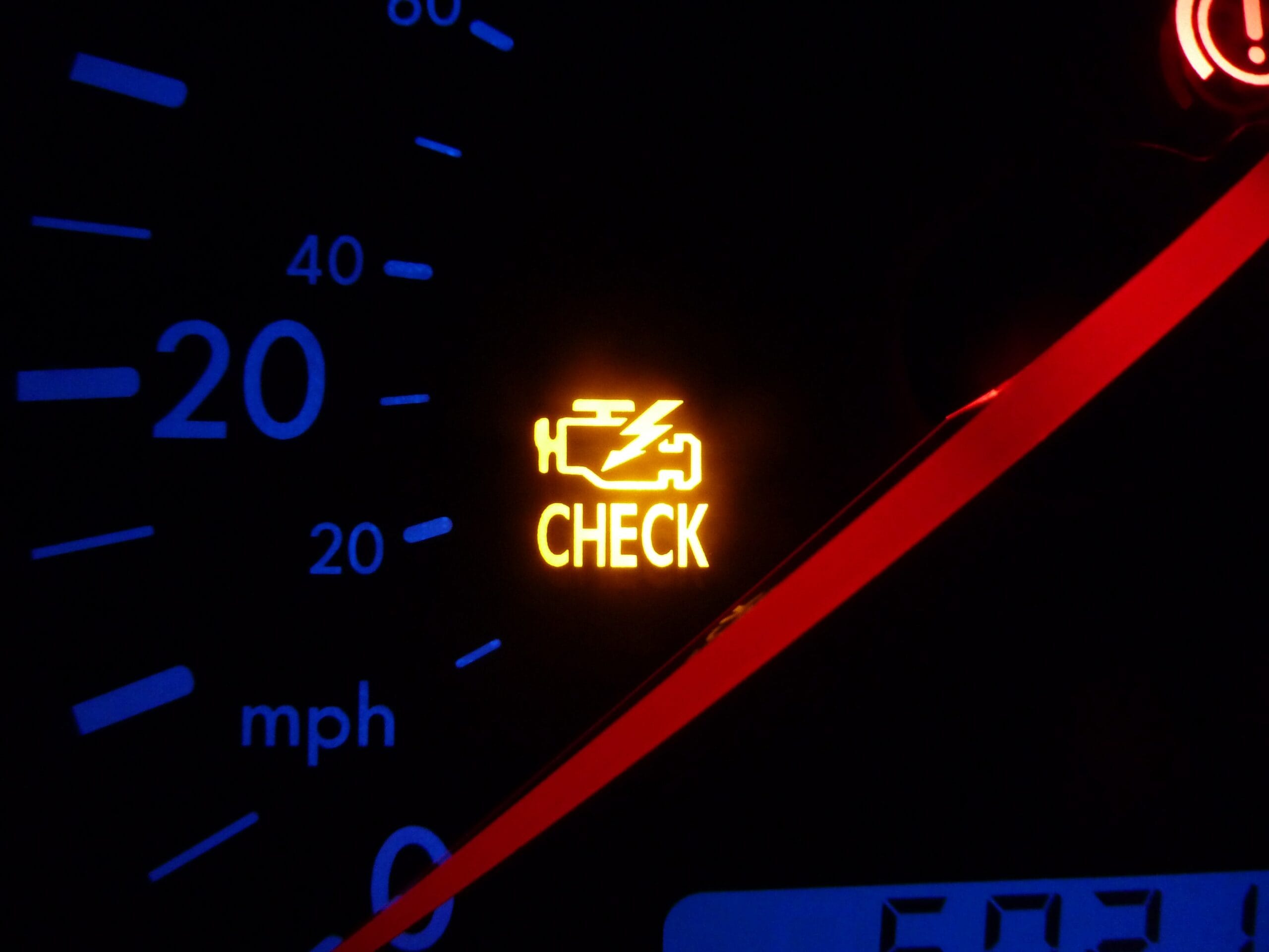 A glowing yellow check engine light on a car dashboard, representing common engine codes like P0420 or misfires.