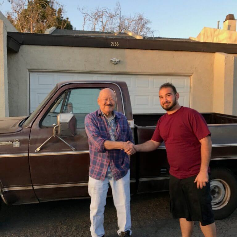 Sonny Miller from GoCarBuyer inspecting a classic Chevy truck for purchase in Southern California.