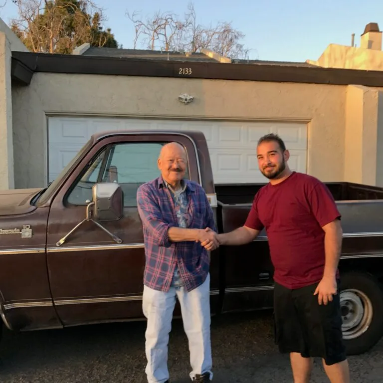 Sonny Miller from GoCarBuyer inspecting a classic Chevy truck for purchase in Southern California.