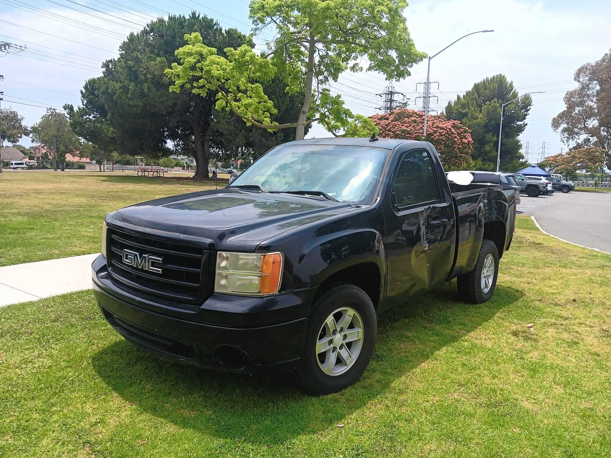 A used black GMC Sierra regular cab pickup truck purchased for cash by GoCarBuyer in San Diego, California