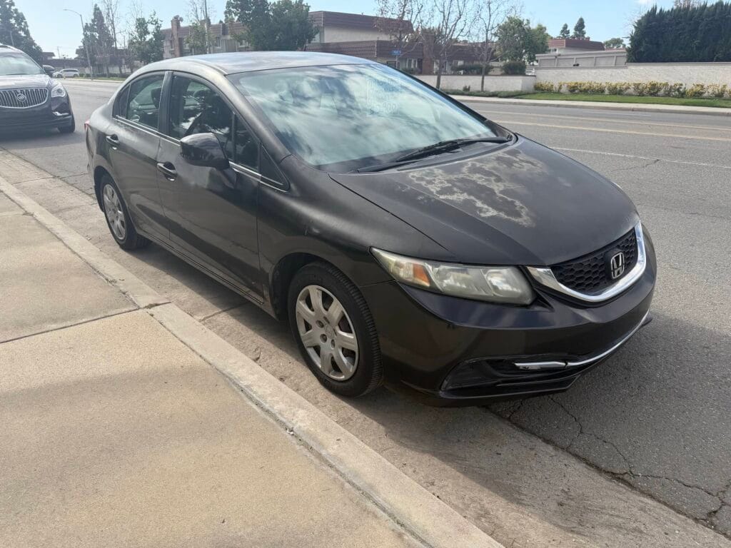A used black Honda Civic sedan purchased for cash by GoCarBuyer in San Diego, California with bad brakes.