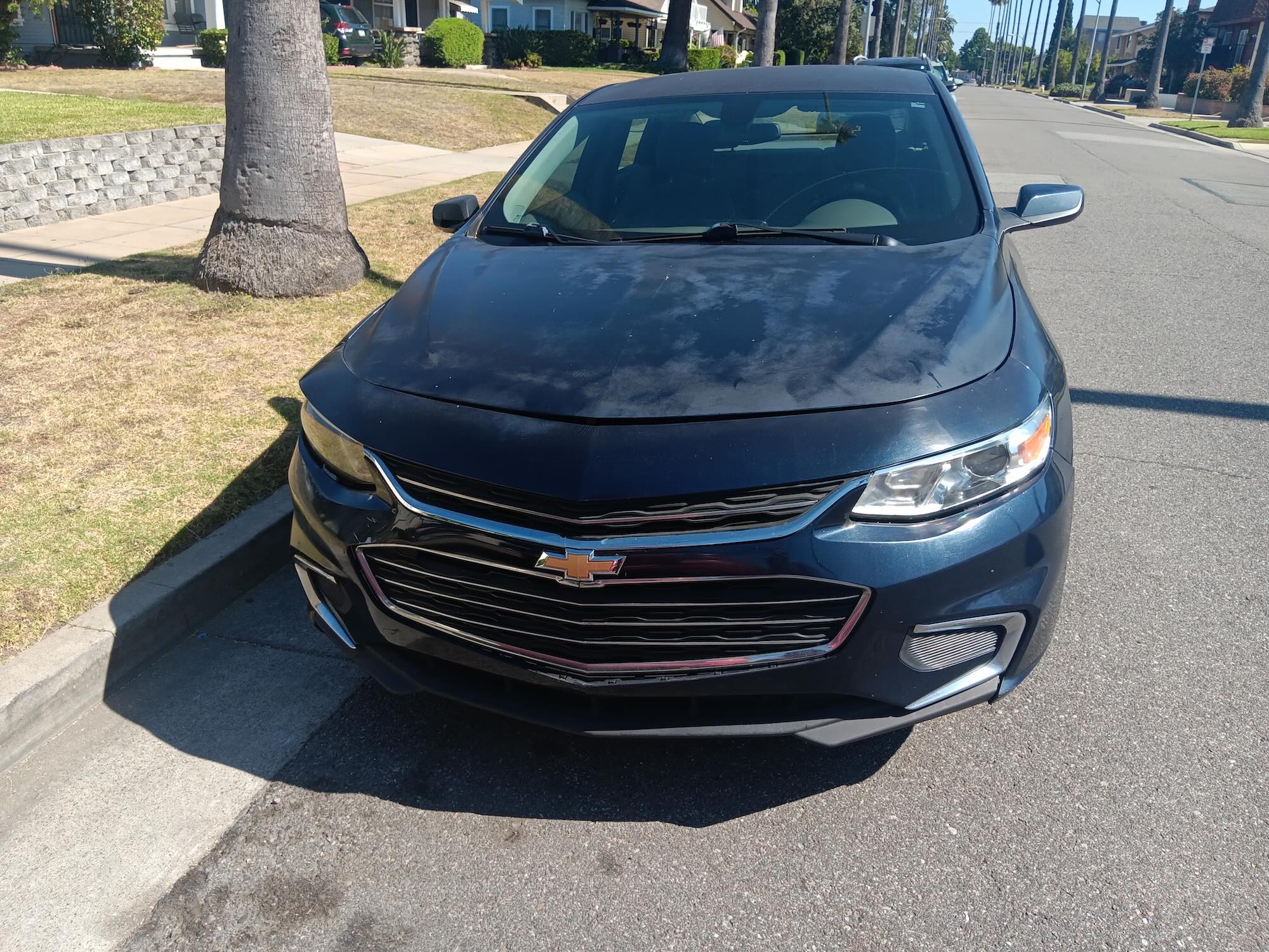 A used dark blue Chevrolet Malibu sedan purchased for cash by GoCarBuyer in Orange County, California