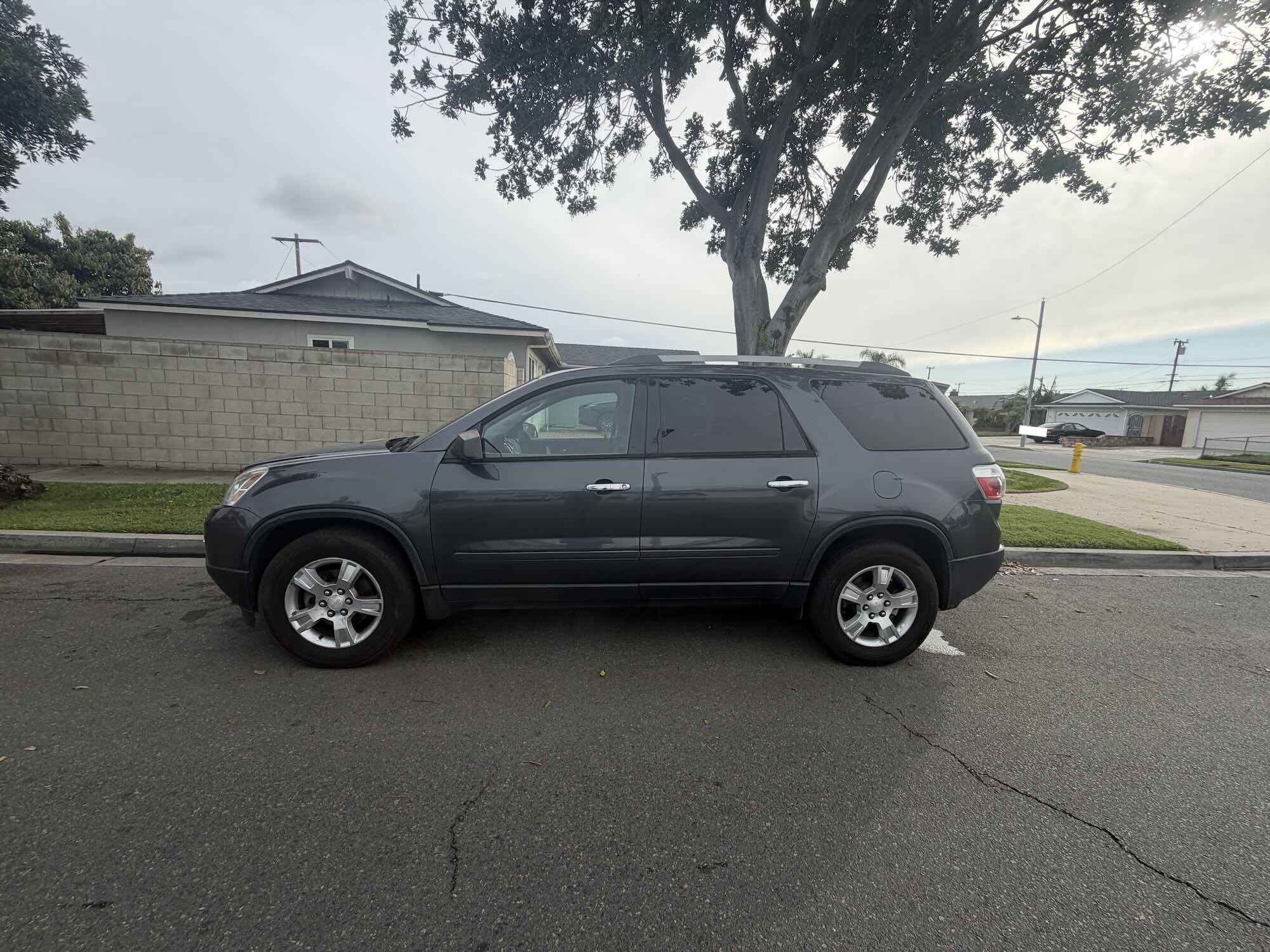 A used dark grey GMC Acadia SUV purchased for cash by GoCarBuyer in Riverside, California