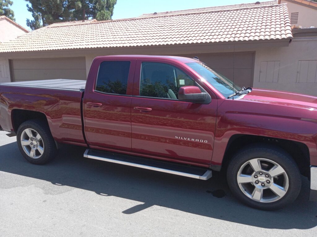 A used maroon Chevrolet Silverado 1500 double cab pickup truck purchased for cash by GoCarBuyer in Orange County, California