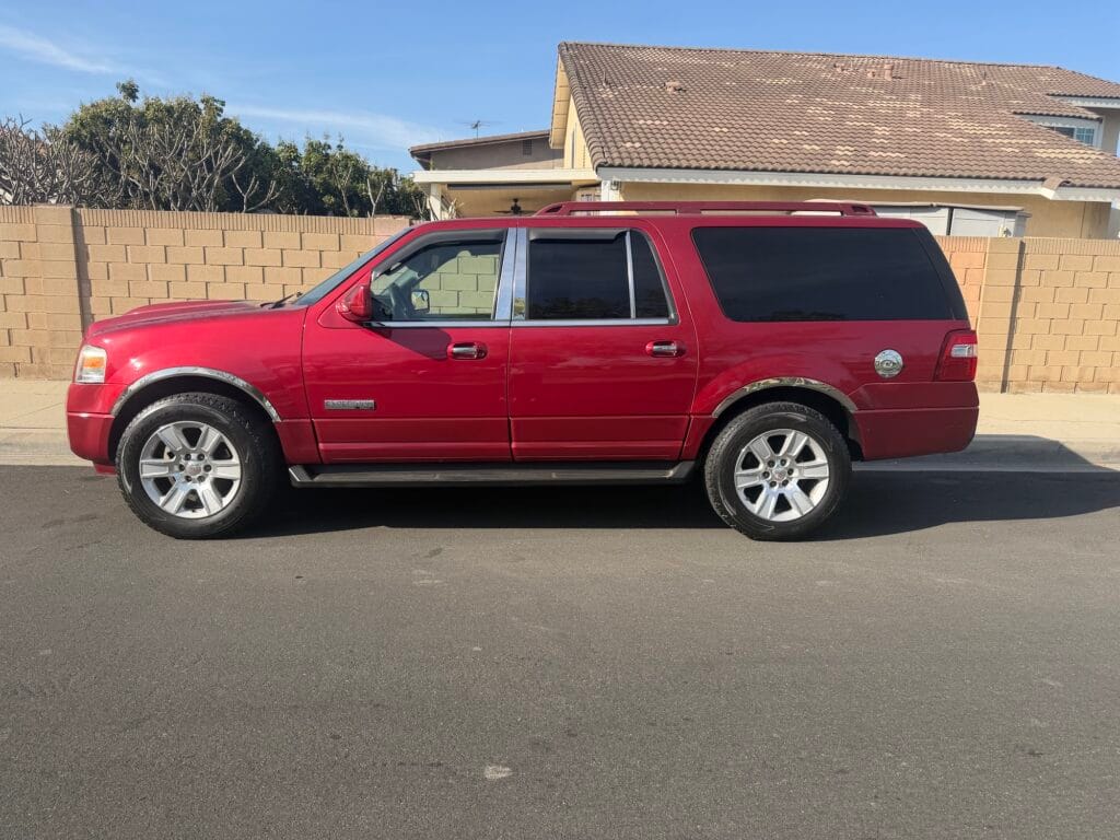 A used red Ford Expedition EL extended-length SUV purchased for cash by GoCarBuyer in San Diego, California we buy vehicles out of state titles