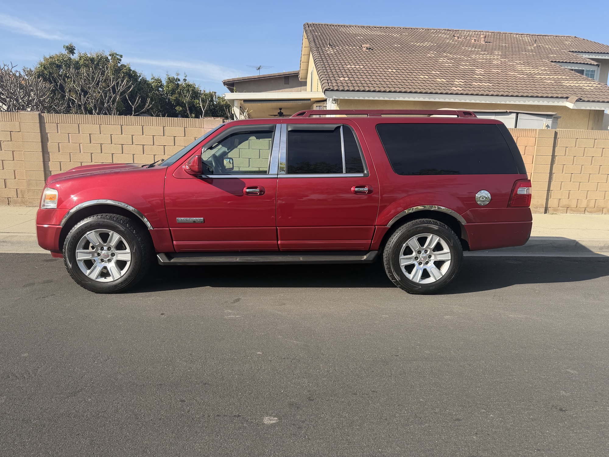A used red Ford Expedition EL extended-length SUV purchased for cash by GoCarBuyer in San Diego, California