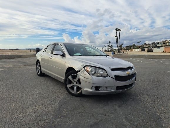 A used silver Chevrolet Malibu sedan purchased for cash by GoCarBuyer in Los Angeles, California
