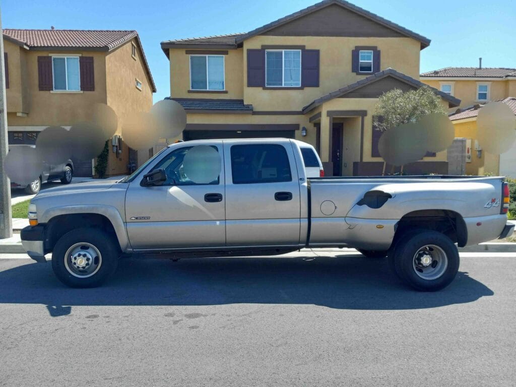 A used silver Chevrolet Silverado 3500 dually 4x4 crew cab purchased for cash by GoCarBuyer in San Bernardino, California