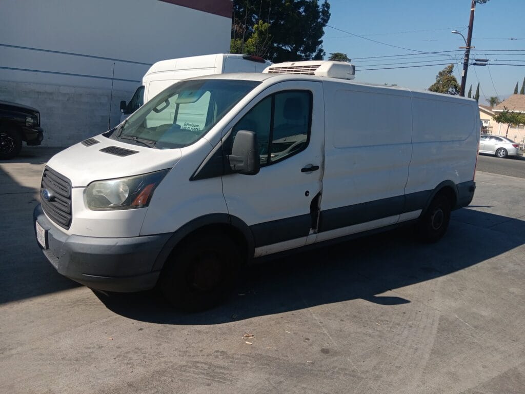 A used white Ford Transit refrigerated cargo van purchased for cash by GoCarBuyer in San Bernardino, California