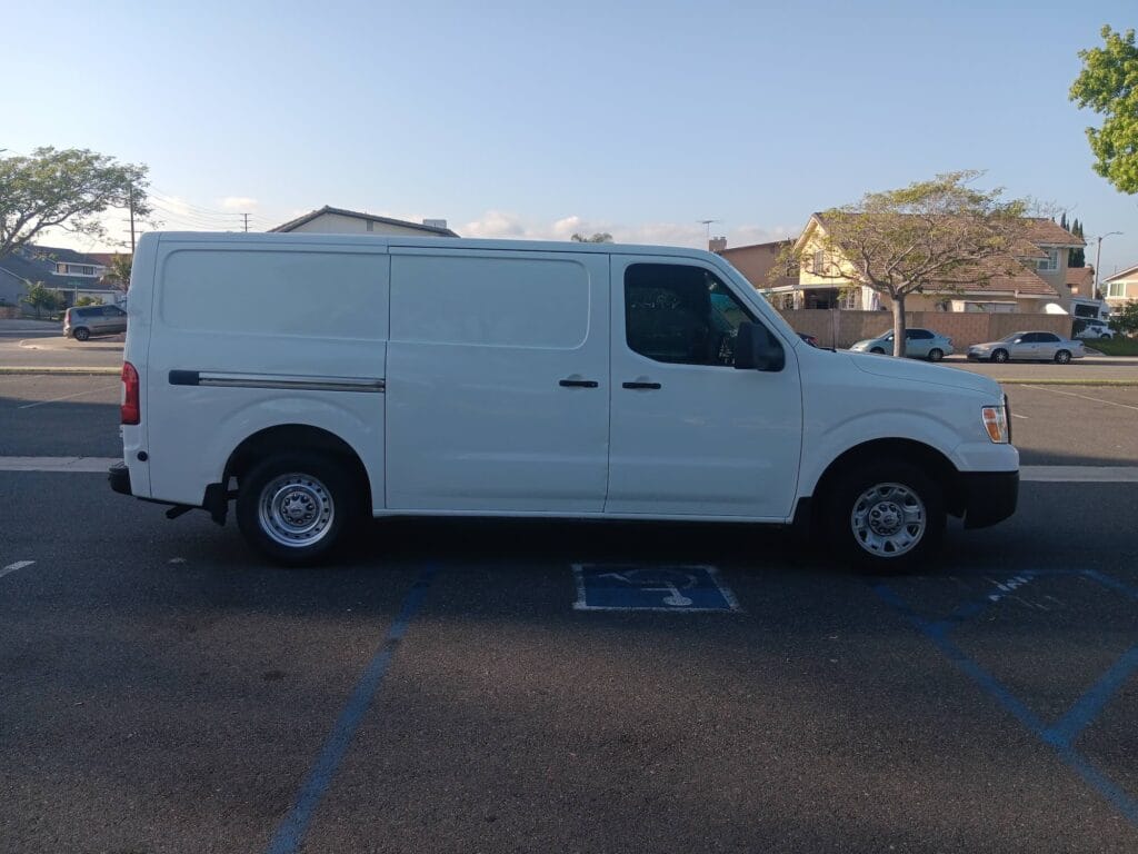 A used white Nissan NV cargo van purchased for cash by GoCarBuyer in San Diego, California