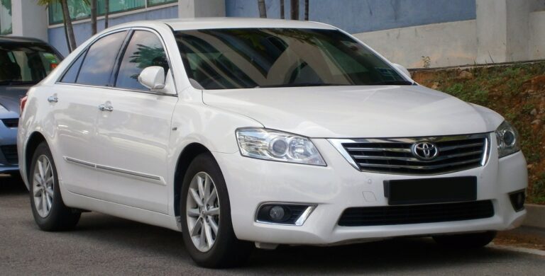 White 2009 Toyota Camry. We buy high-mileage and damaged Camrys for cash across Southern California.