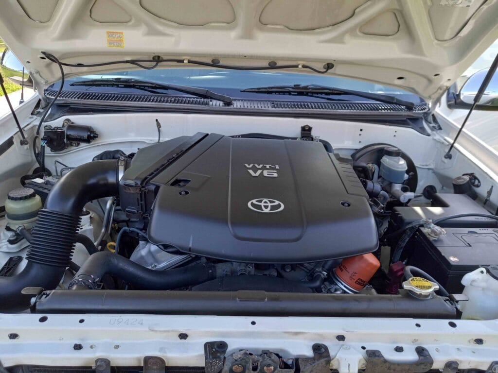 A perfectly detailed vehicle engine bay showing a spotless V6 engine after being cleaned with all-purpose cleaner.