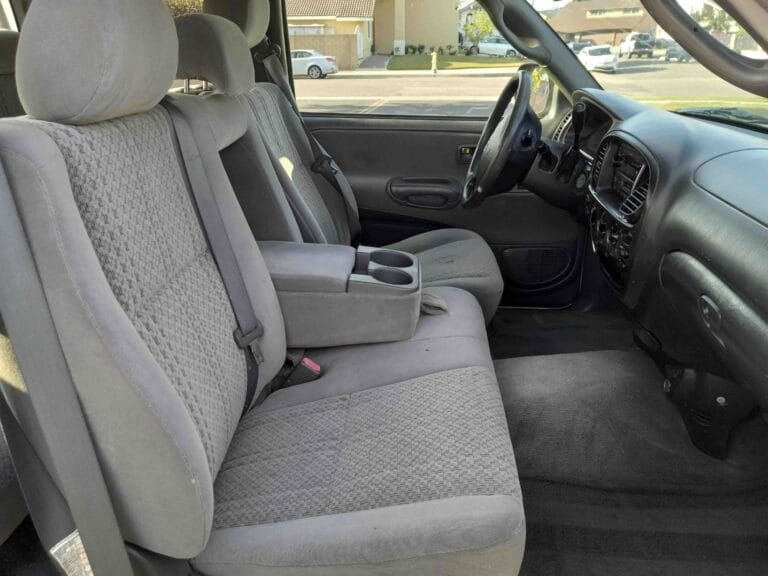 Clean gray cloth car interior showing freshly vacuumed carpets and stain-free seats.