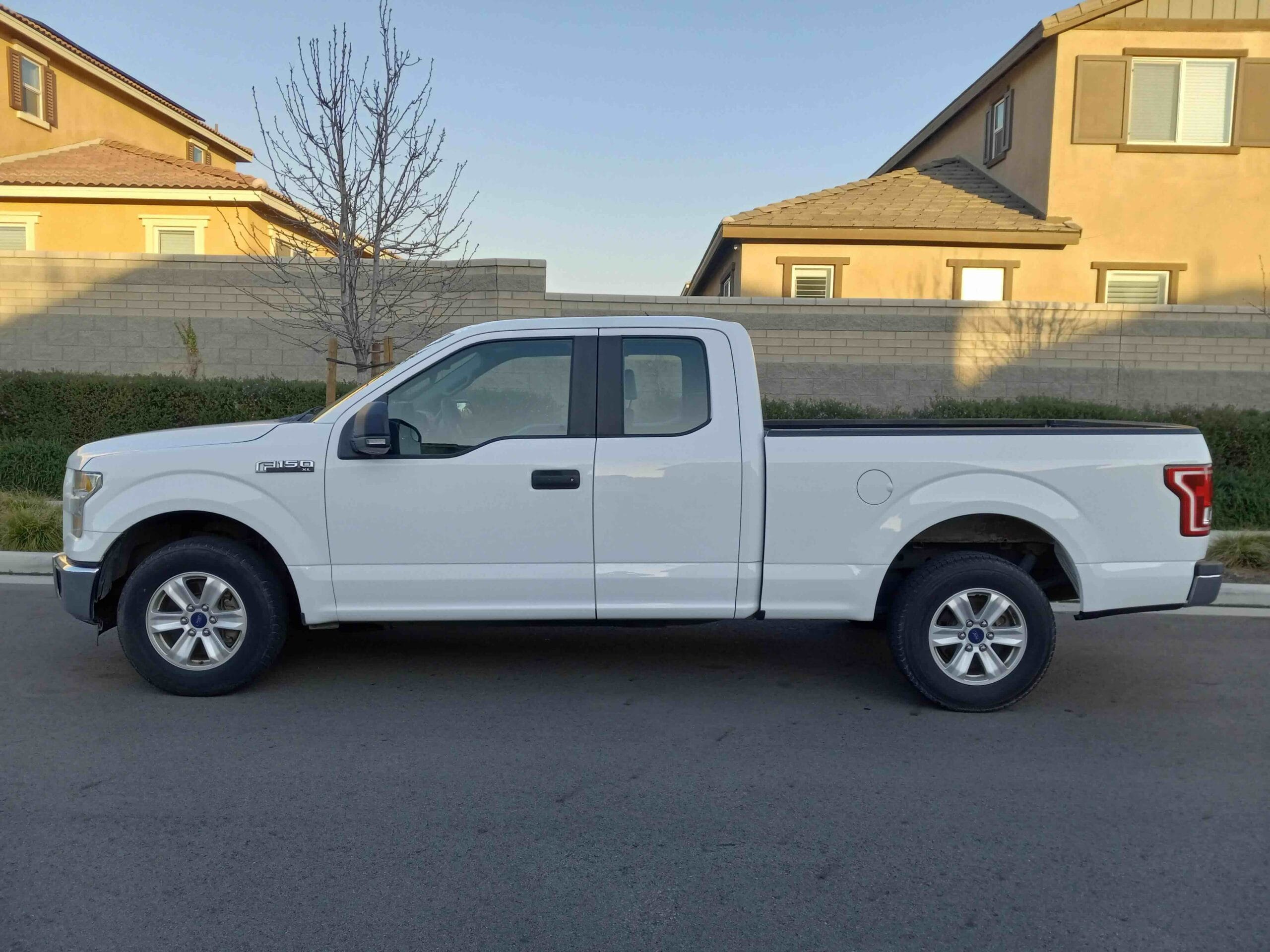 White Ford F-150 SuperCab pickup truck parked in a residential neighborhood in Riverside County
