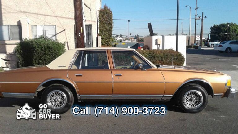 A clean, survivor-condition gold classic Chevy Caprice square body parked on an industrial street in Los Angeles. Local SoCal car buyer paying cash for 1977-1990 box Chevys in any condition.