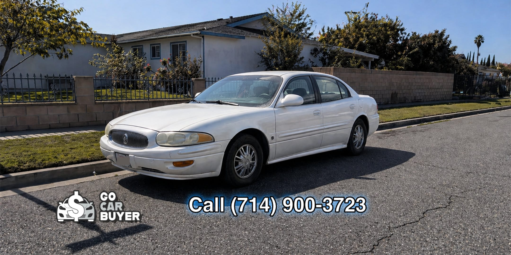 A well-kept white Buick LeSabre parked in a Southern California neighborhood. Local car buyer purchasing elderly-owned vehicles for top dollar cash, check, or Zelle.