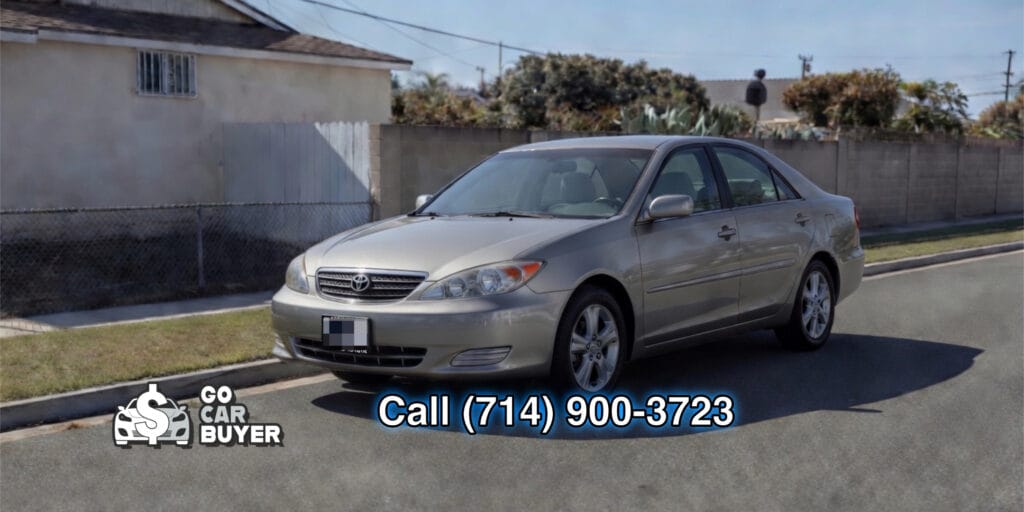 A clean silver early 2000s Toyota Camry parked on a residential street in Southern California. Local car buyer purchasing elderly-owned vehicles and commuter cars for cash.