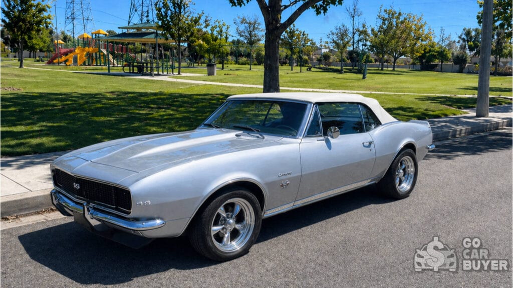 A classic silver first-generation Chevrolet Camaro SS convertible parked outdoors in Southern California. GoCarBuyer purchases classic Camaros, including SS, RS, Z28, and project cars, directly from owners.